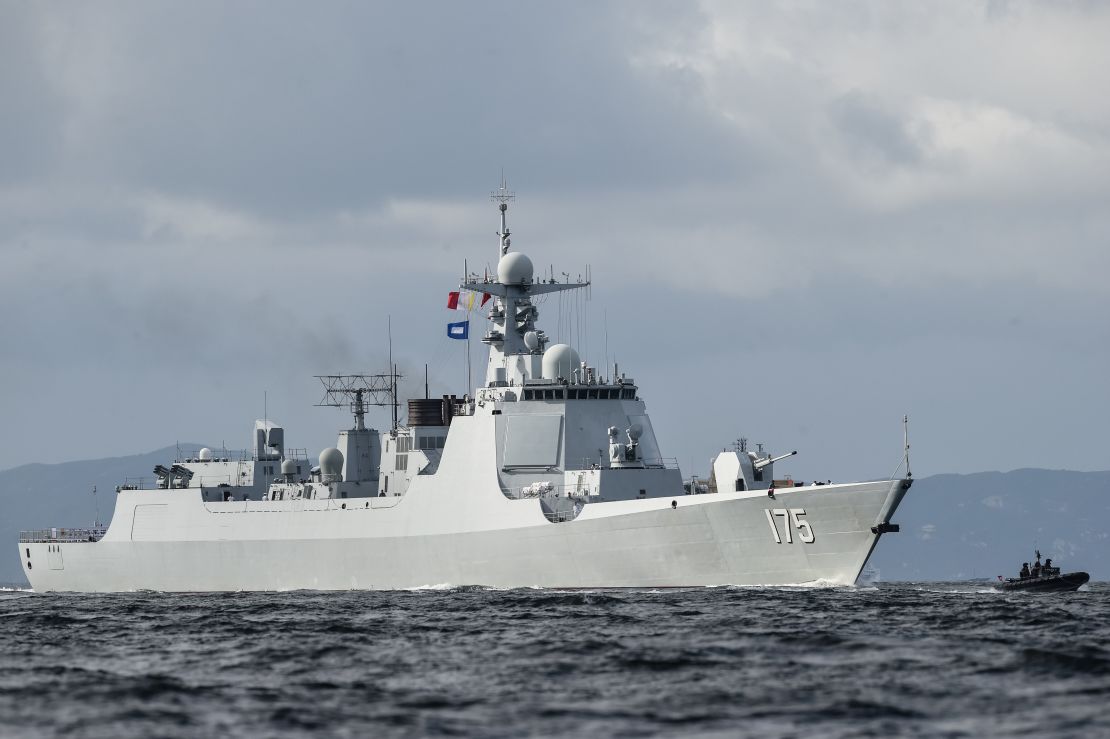A Type 052D destroyer of China's People's Liberation Army Navy provides an escort ahead of the Liaoning aircraft carrier into the Lamma Channel as it arrives in Hong Kong territorial waters on July 7, 2017.