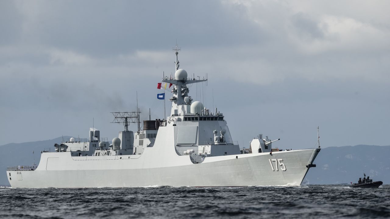 A Type 052D destroyer of China's People's Liberation Army Navy provides an escort ahead of the Liaoning aircraft carrier into the Lamma Channel as it arrives in Hong Kong territorial waters on July 7, 2017.