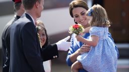Britain's Princess Kate, the Duchess of Cambridge holds her daughter Princess Charlotte as they arrive at the airport in Berlin on July 19, 2017.
The British royal couple is on a three-day-visit in Germany. / AFP PHOTO / Steffi LOOS        (Photo credit should read STEFFI LOOS/AFP/Getty Images)