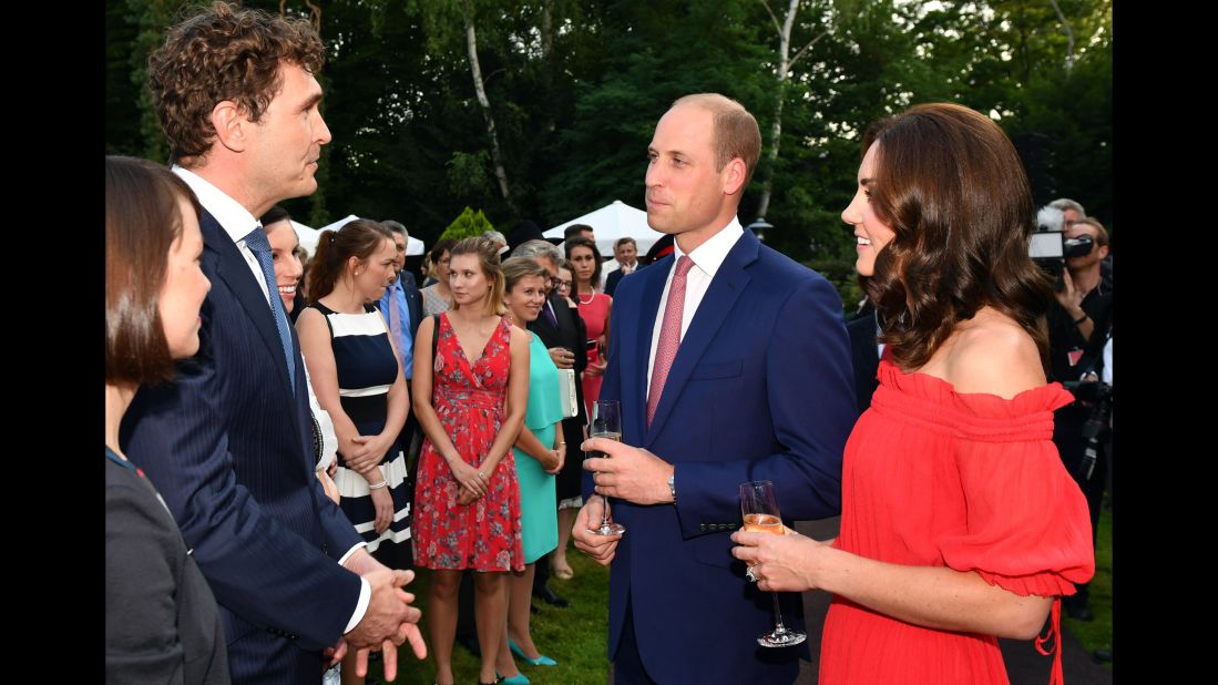 The royal couple speaks with General Secretary of DFB Friedrich Curtius, left, during the Queen's Birthday Garden Party.