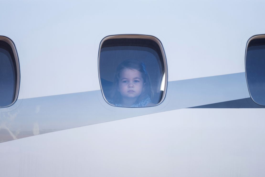 Princess Charlotte peers out of the airplane window upon the arrival at the airport in Berlin on Wednesday.