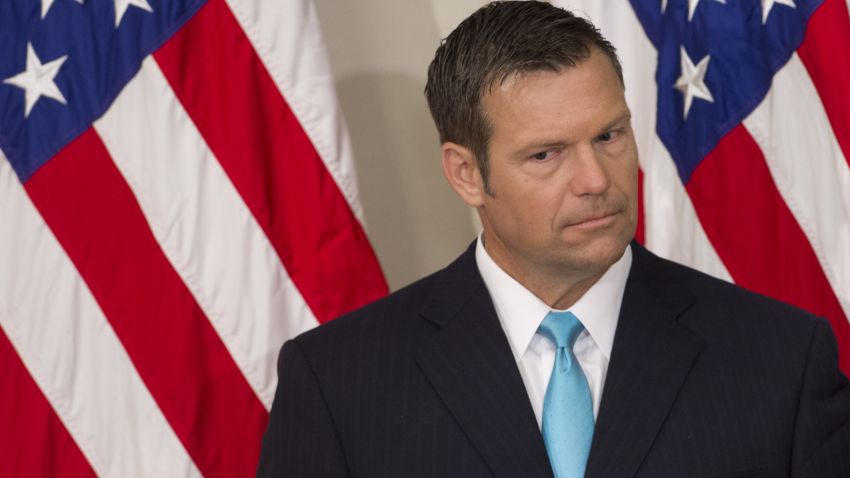 Kansas Secretary of State Kris Kobach listens as US President Donald Trump speaks during the first meeting of the Presidential Advisory Commission on Election Integrity in the Eisenhower Executive Office Building next to the White House in Washington, DC, July 19, 2017. / AFP PHOTO / SAUL LOEB        (Photo credit should read SAUL LOEB/AFP/Getty Images)