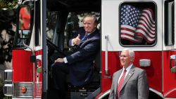 WASHINGTON, DC - JULY 17:  U.S. President Donald Trump gives a thumbs up to journalists from inside a fire engine made by Pierce Manufacturing while touring a Made in America product showcase with Vice President Mike Pence on the South Lawn of the White House July 17, 2017 in Washington, DC. American manufacturers representing each of the 50 states participated in the showcase, including Bully Tools, Cheerwine, Stetson, Simms and RMA Armament, Charles Machine Works, Honckley Yachts, Altec Inc., Caterpiller, Pierce Manufacturing and others.  (Photo by Chip Somodevilla/Getty Images) ***BESTPIX***