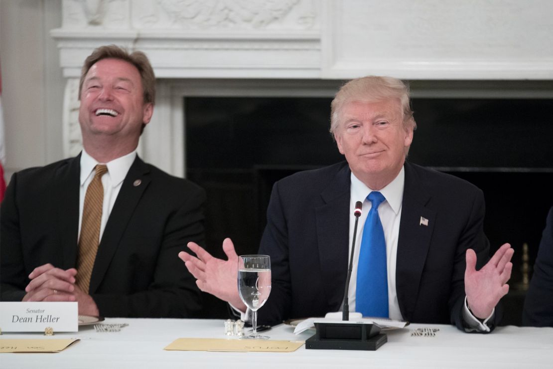 President Donald Trump (R) delivers remarks on health care and Republicans' inability thus far to replace or repeal the Affordable Care Act, beside Sen. Dean Heller (R-NV) (L) during a lunch with members of Congress in the State Dining Room of the White House on July 19, 2017 in Washington, DC. (Photo by Michael Reynolds - Pool/Getty Images)