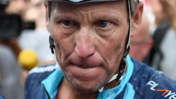 US cyclist Lance Armstrong looks on upon his arrival in Rodez, southwest France, after riding a stage  of The Tour De France for a leukaemia charity, a day ahead of the competing riders, on July 16, 2015. For the first time since he was stripped of his seven Tour de France titles, disgraced cyclist Lance Armstrong rode a stage of the famous race for charity. Armstrong, 43, was riding a 198-kilometre (123-mile) stage a day ahead of the competing riders for a leukaemia charity but cycling officials have branded the exercise "disrespectful". AFP PHOTO / STEPHANE DE SAKUTIN        (Photo credit should read STEPHANE DE SAKUTIN/AFP/Getty Images)