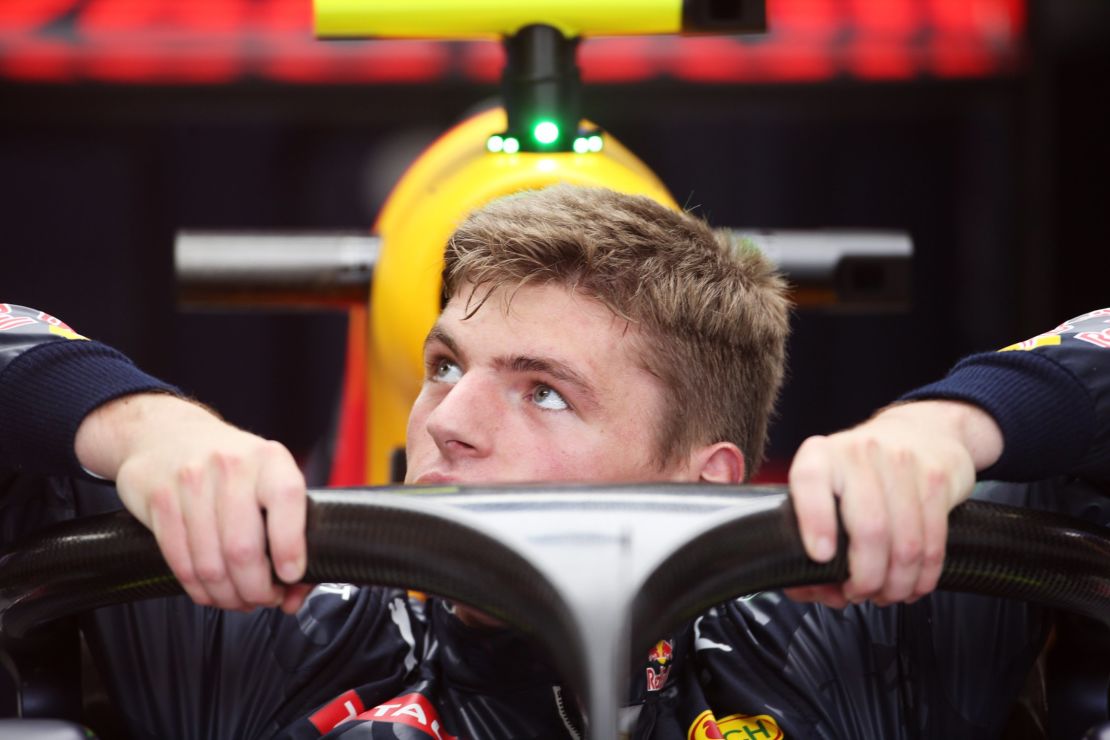 Max Verstappen slips into his Red Bull car fitted with the 'Halo" at the 2016 Italian Grand Prix weekend.