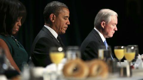 From left: First lady Michelle Obama, President Barack Obama and Sessions pray during the 2013 National Prayer Breakfast in Washington.
