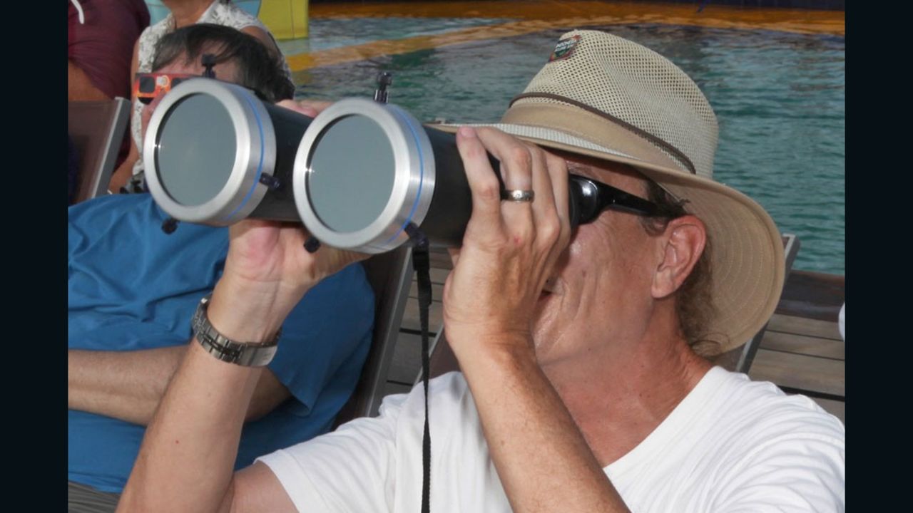 Bill Kramer observing a total solar eclipse through solar filtered binoculars while in Indonesia in 2016.