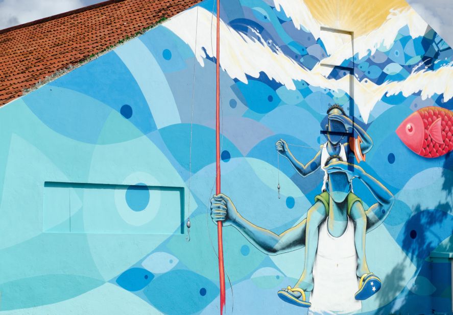 <strong>Enjoy street art:</strong> Colorful life-size murals around Willemstad's colonial districts are turning the city into an outdoor gallery. 