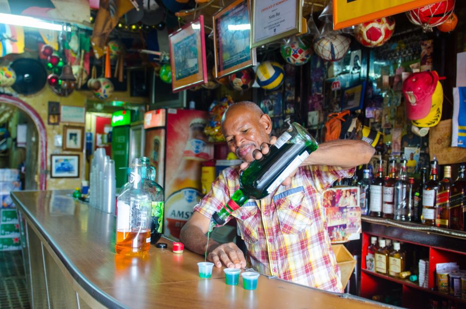 <strong>Knock back some rum:</strong> Located in Willemstad's Otrobanda area, Netto Bar has been making, bottling and serving shots of <em>rom berde</em> (green rum) since 1954.