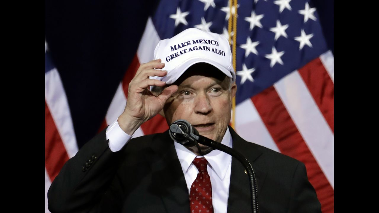 Sessions wears a "Make Mexico Great Again Also" hat before a Trump speech during a campaign rally at the Phoenix Convention Center in August  2016.