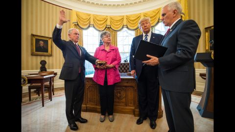 Vice President Mike Pence swears in Sessions as attorney general while Sessions' wife and President Trump look on in the Oval Office on February 9, 2017. Sessions was approved after a contentious battle along party lines.