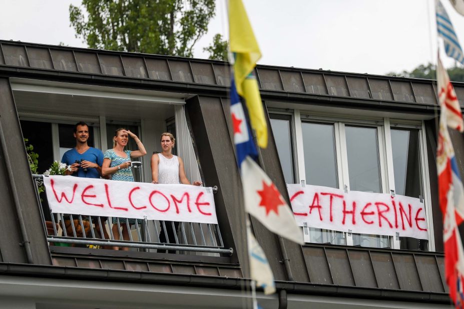 Residents stand on a balcony decorated with a banner welcoming the Duchess of Cambridge to Heidelberg, Germany.