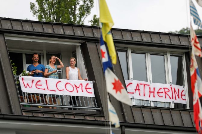 Residents stand on a balcony decorated with a banner welcoming the Duchess of Cambridge to Heidelberg, Germany.
