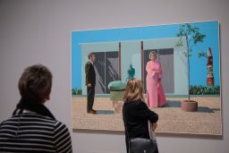 Visitors view "American Collectors (Fred and Marcia Weisman)" by David Hockney.