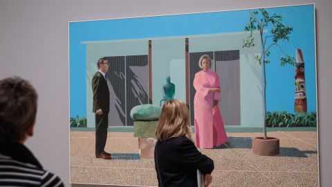 Visitors view "American Collectors (Fred and Marcia Weisman)" by David Hockney.