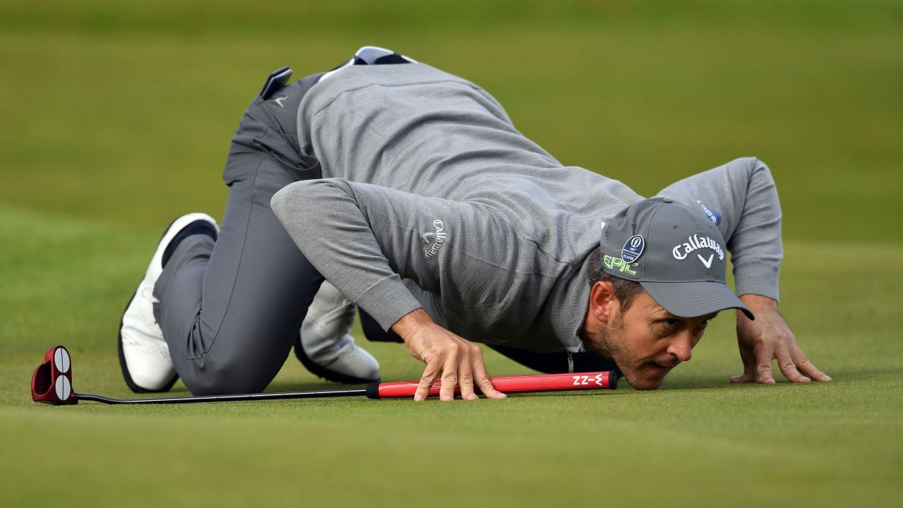 Wales' Stuart Manley lines up a putt on the eighth green during his opening round. Wet, cool and breezy conditions, as well as enthusiastic crowds, greeted the first group of players to go out at 6:35 a.m.