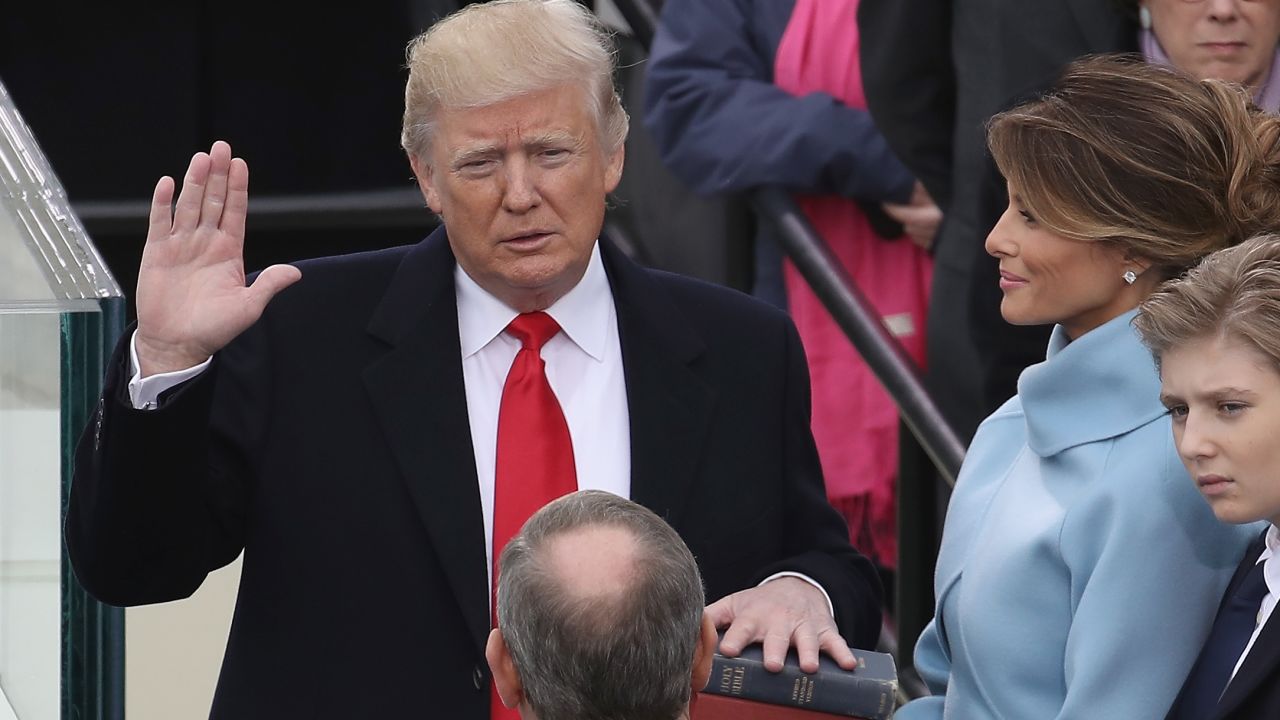 WASHINGTON, DC - JANUARY 20:  Supreme Court Justice John Roberts (2L) administers the oath of office to U.S. President Donald Trump (L) as his wife Melania Trump holds the Bible and son Barron Trump looks on, on the West Front of the U.S. Capitol on January 20, 2017 in Washington, DC. In today's inauguration ceremony Donald J. Trump becomes the 45th president of the United States.  (Photo by Drew Angerer/Getty Images)