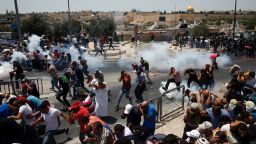 Palestinian worshippers run for cover from teargas, fired by Israeli forces, following prayers outside Jerusalem's Old City in front of the Al-Aqsa mosque compound after Israeli police barred men under 50 from entering the Old City for Friday Muslim prayers as tensions rose and protests erupted over new security measures at the highly sensitive holy site on July 21, 2017.
The ban came after Israeli ministers decided not to order the removal of metal detectors erected at entrances to the Haram al-Sharif mosque compound, known to Jews as the Temple Mount, following an attack nearby a week ago that killed two policemen. / AFP PHOTO / AHMAD GHARABLI        (Photo credit should read AHMAD GHARABLI/AFP/Getty Images)