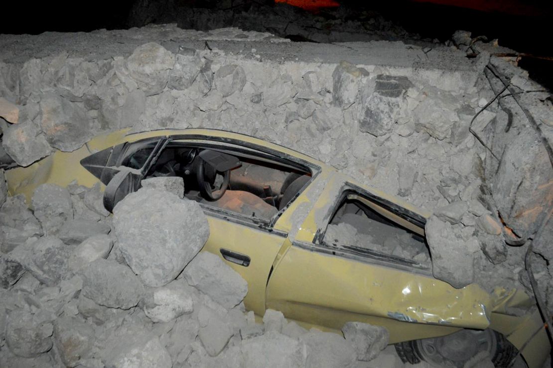A car is enveloped in rubble on Kos in the wake of the earthquake. 