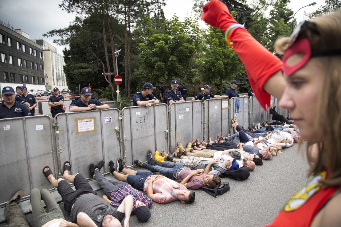 Protesters lay under barriers near Polish parliament.