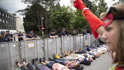 Protesters lay under barriers near Polish parliament.