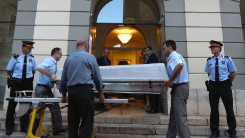 Undertakers take a casket inside for the exhumation of Salvador Dali's remains in Figueras on July 20.