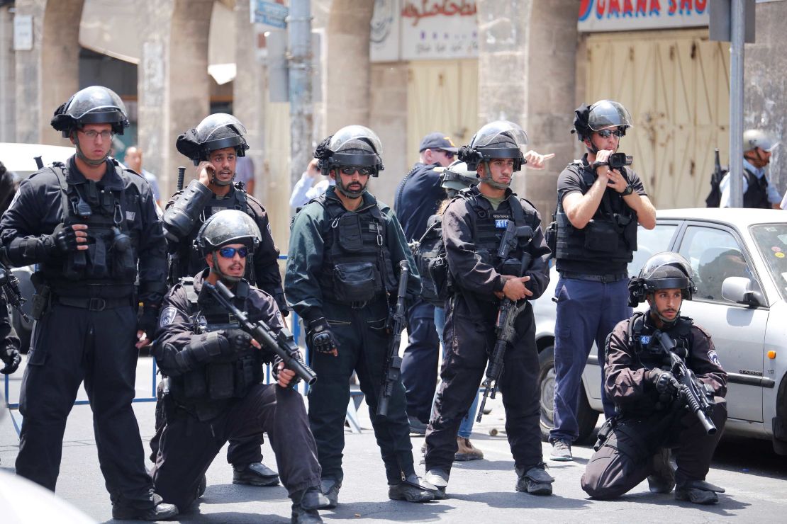 Israeli security forces take security measures as Palestinians gather for Friday prayers outside Herod's Gate in Jerusalem.