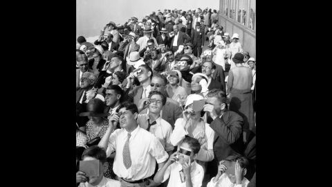 On August 31, 1932, people squinted through protective film to see a partial eclipse of the sun from the top deck of New York's Empire State Building. 