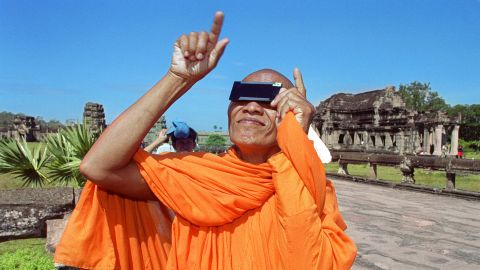 A Cambodian monk watches the beginning of a full solar eclipse with safety glasses in October 1995, during a total eclipse at Angkor Wat. Thousands of tourists and locals witnessed the eclipse at the 12th century monument. 