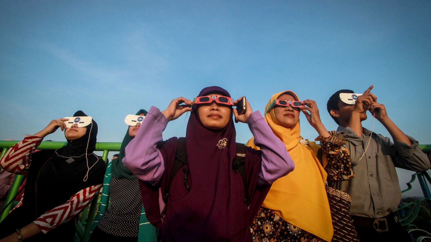 Indonesians use special glasses to observe the solar eclipse on March 09, 2016 in Surakarta, Indonesia.