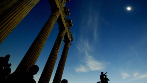 Tourists watch the full solar eclipse in the second century Greek Temple of Apollo in Side, Antalya, on the southern coast of Turkey in March 2006.