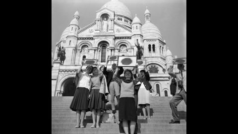 Parisians watching the solar eclipse with the help of smoked glass on the steps of Sacre-Coeur, Paris, France, in October 1959. 