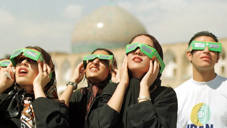 Iranian teenagers observed the solar eclipse in front of Sheikh Lotfollah Mosque in Naghsh-e Jahan Square, in Isfahan, Iran on  August 11, 1999.   