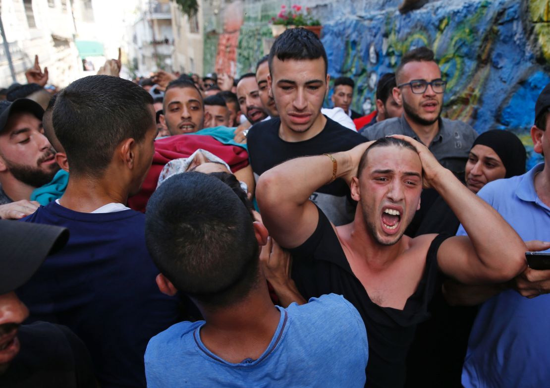 Palestinians on Friday carry the body of a man who was killed during clashes with Israeli forces.