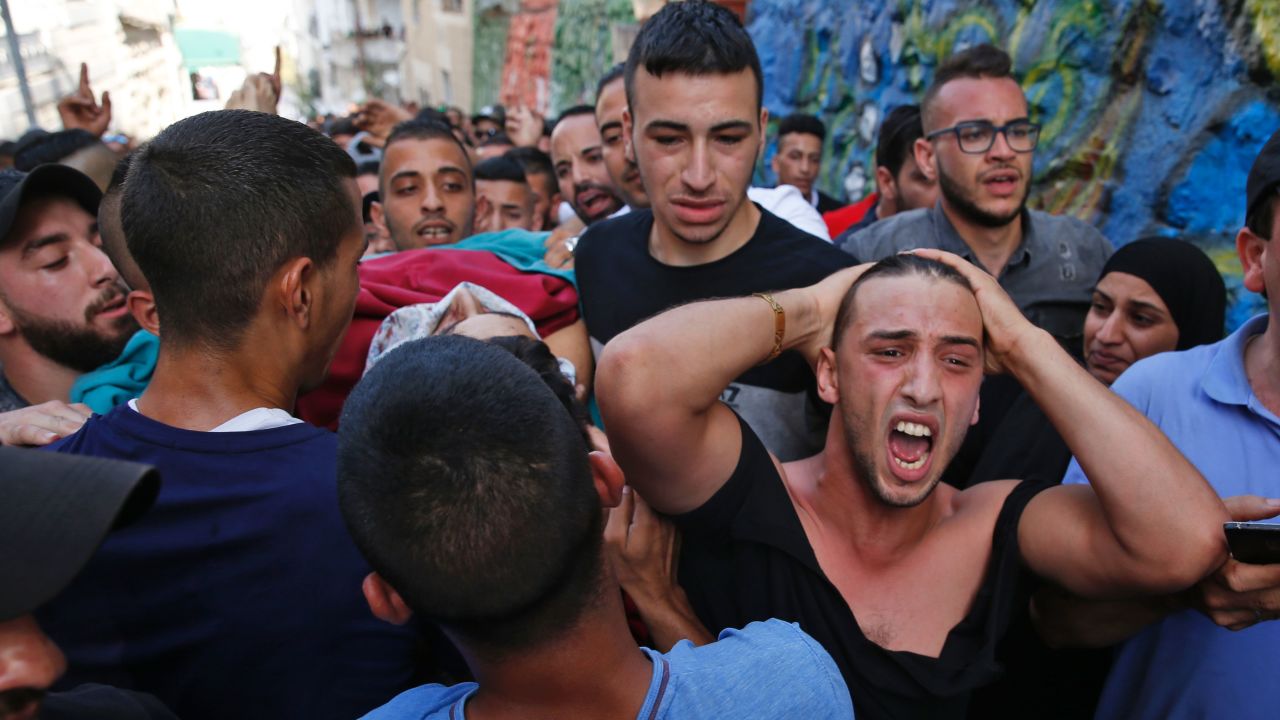 Palestinians on Friday carry the body of a man who was killed during clashes with Israeli forces.