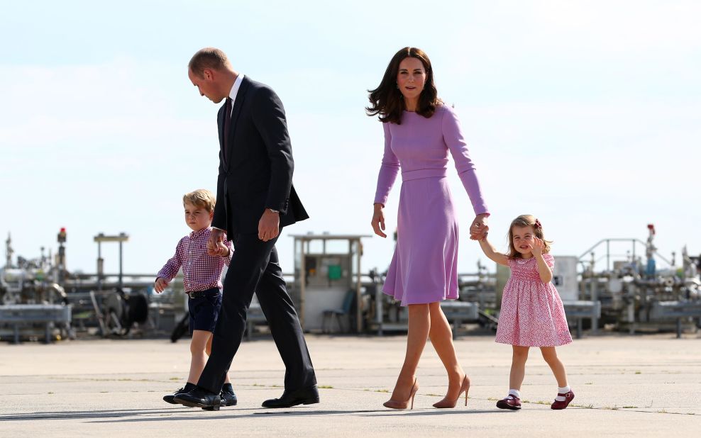 Britain's Prince William, Duke of Cambridge, and his wife Catherine, Duchess of Cambridge, and their children Prince George and Princess Charlotte walk on the tarmac of the Airbus compound in Hamburg, northern Germany, before boarding their plane on Friday, July 21. The royal family visited Germany and Poland on a five-day European tour.