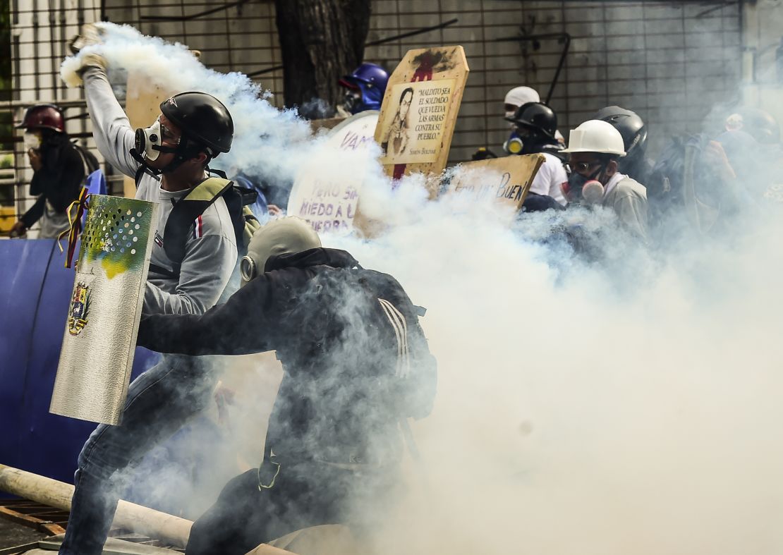 Demonstrators clash with riot police during an anti-government protest in Caracas on July 20, 2017. 
