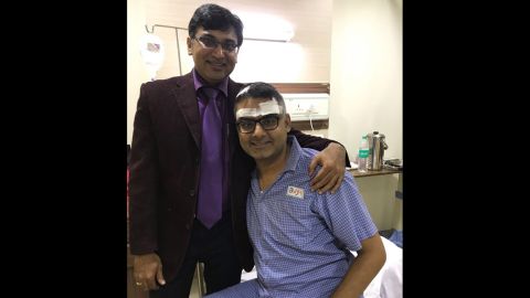 Neurosurgeon Dr. Sharan Srinivasan visits with Abhishek Prasad after the guitar player's brain surgery.
