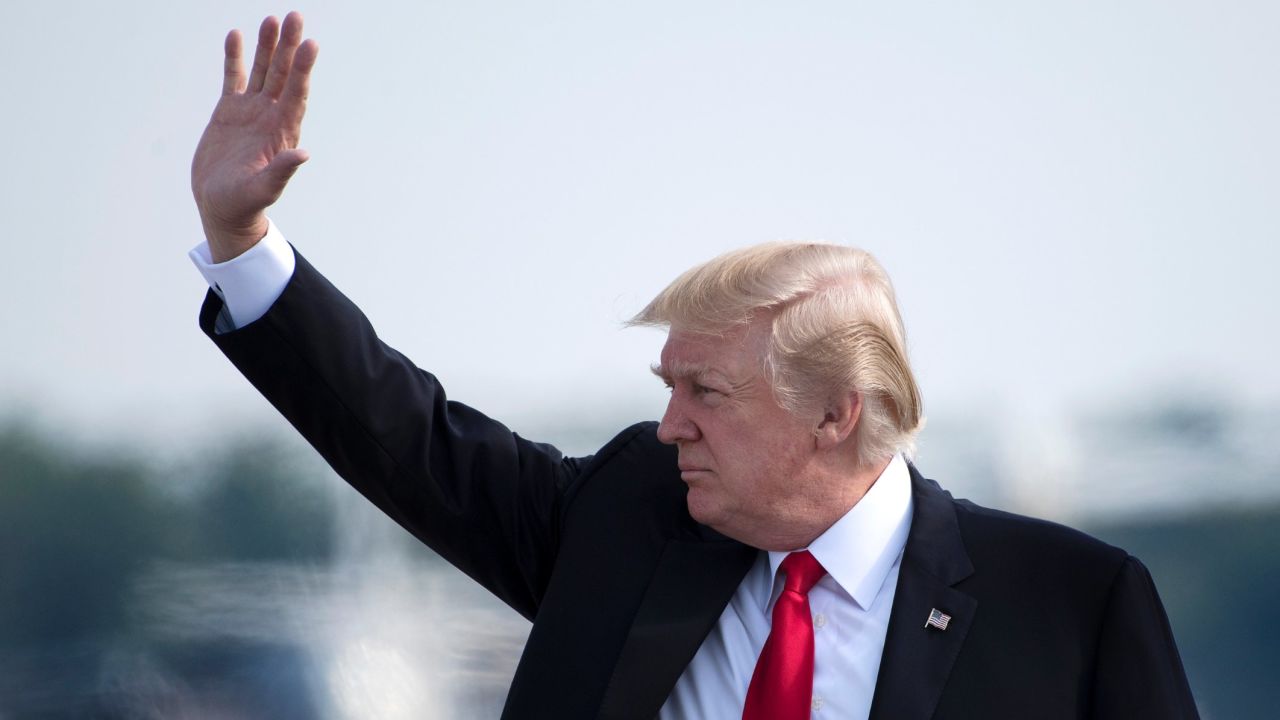 US President Donald Trump waves as he boards Air Force One at Andrews Air Force Base, Maryland, on July 22, 2017.