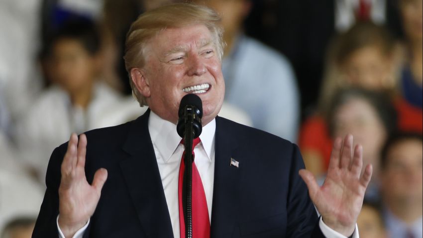 President Donald Trump gestures during a speech aboard the nuclear aircraft carrier USS Gerald R. Ford for it's commissioning at Naval Station Norfolk in Norfolk, Virginia, on July 22, 2017. 