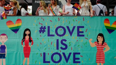 Participants ride in a "Love is Love" float during Berlin's annual Christopher Street Day gay pride parade in July 2017.

