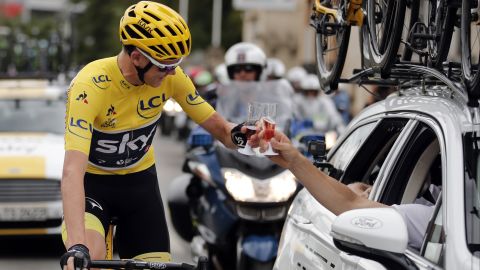 Froome toasts a member of his team during the last stage of the Tour de France race.