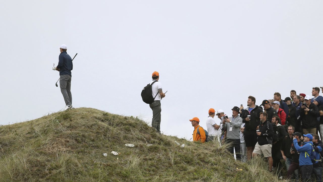 Jordan Spieth of the United States, left, stands on a mound to look at his ball on the 13th hole during the final round of the British Open Golf Championship, at Royal Birkdale, Southport, England, Sunday July 23, 2017. (AP Photo/Peter Morrison)