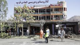 Municipality workers cleans up in front of a wedding hall at the site of a suicide attack in Kabul, Afghanistan, Monday, July 24, 2017. A suicide car bomb killed dozens of people as well as the bomber early Monday morning in a western neighborhood of Afghanistan's capital where several prominent politicians reside, a government official said. (AP Photos/Massoud Hossaini)