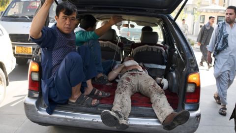 An injured man is transported after the attack in western Kabul on Monday.