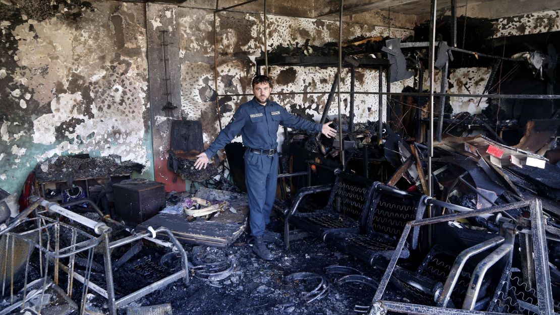 An Afghan security official inspects the scene of the bombing on Monday.