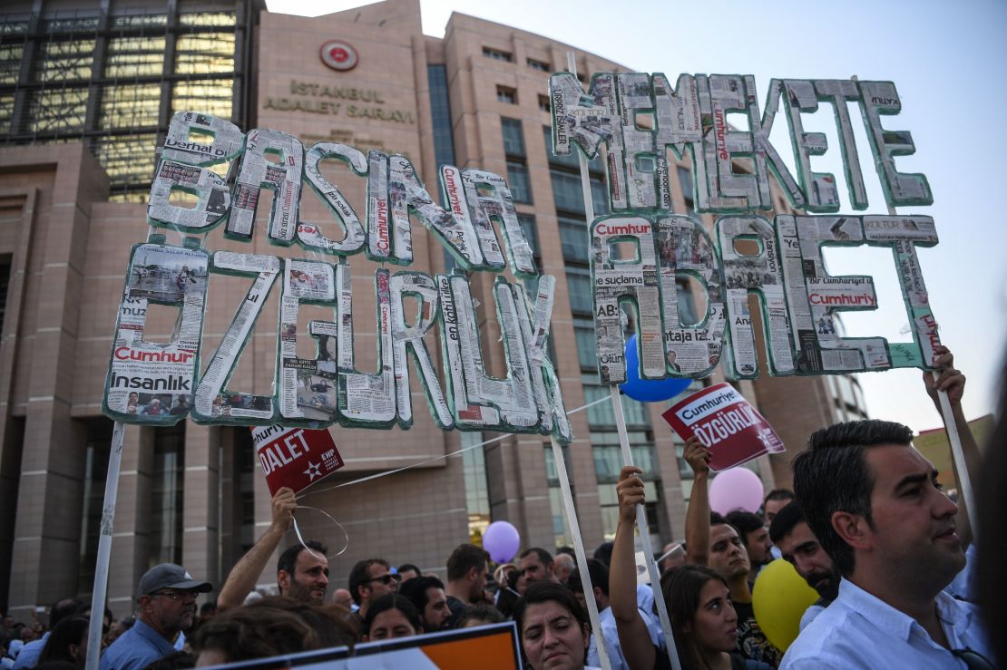 Demonstrators hold banners reading "Freedom for the press - Justice for the country"