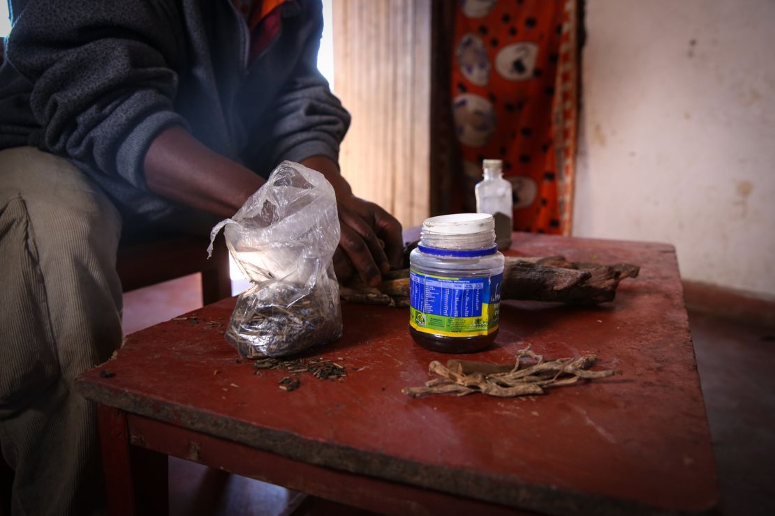 A traditional healer shows a mix of herbs that he uses to induce illegal abortions in Malawi.