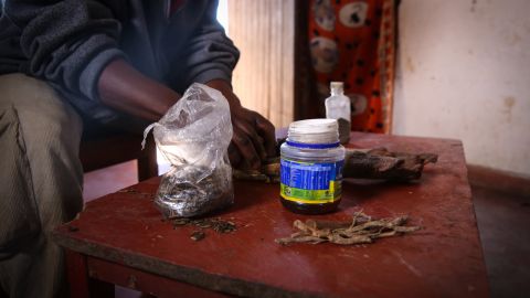 A traditional healer shows a mix of herbs that he uses to induce illegal abortions in Malawi. 